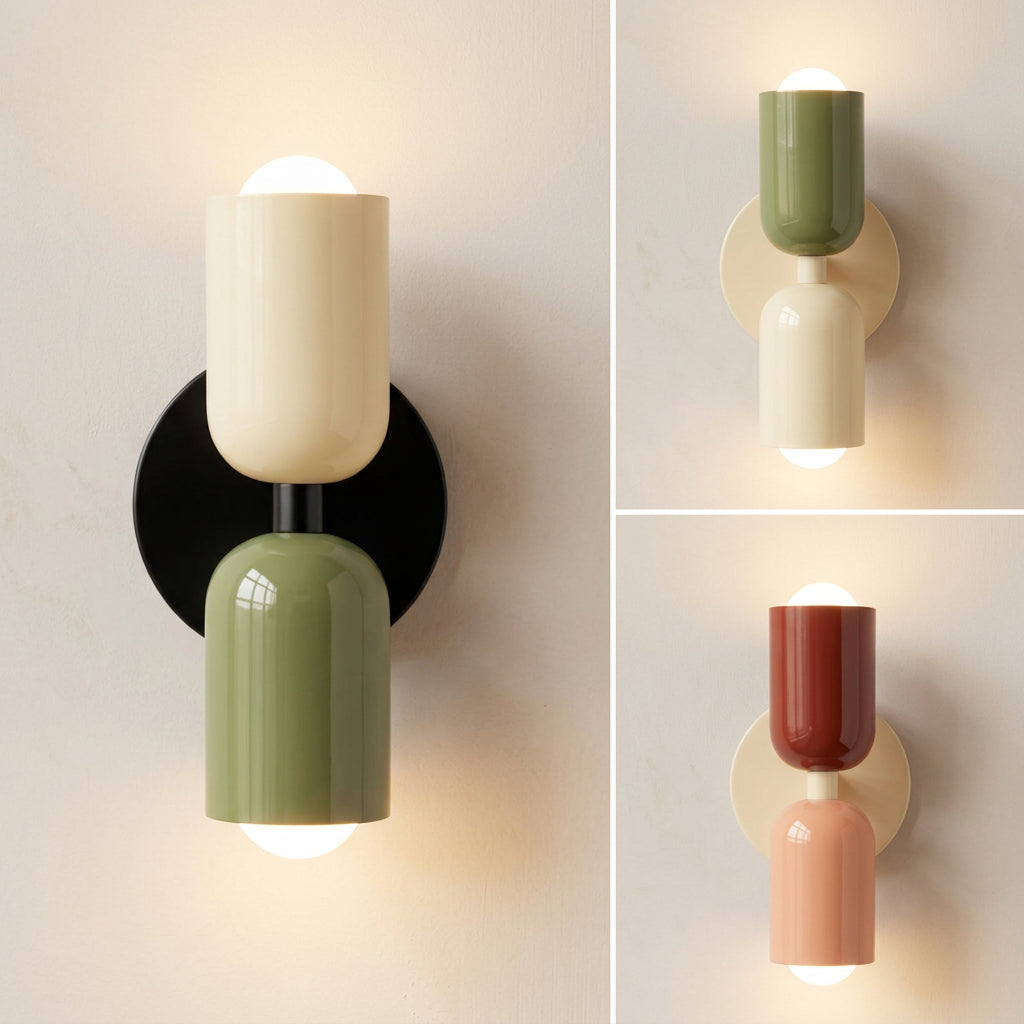 Three views of a modern wall-mounted two-light sconce with cylindrical shades in different colorways: cream, olive green and black; olive green and cream; and terracotta and peach, all mounted on a light beige wall.