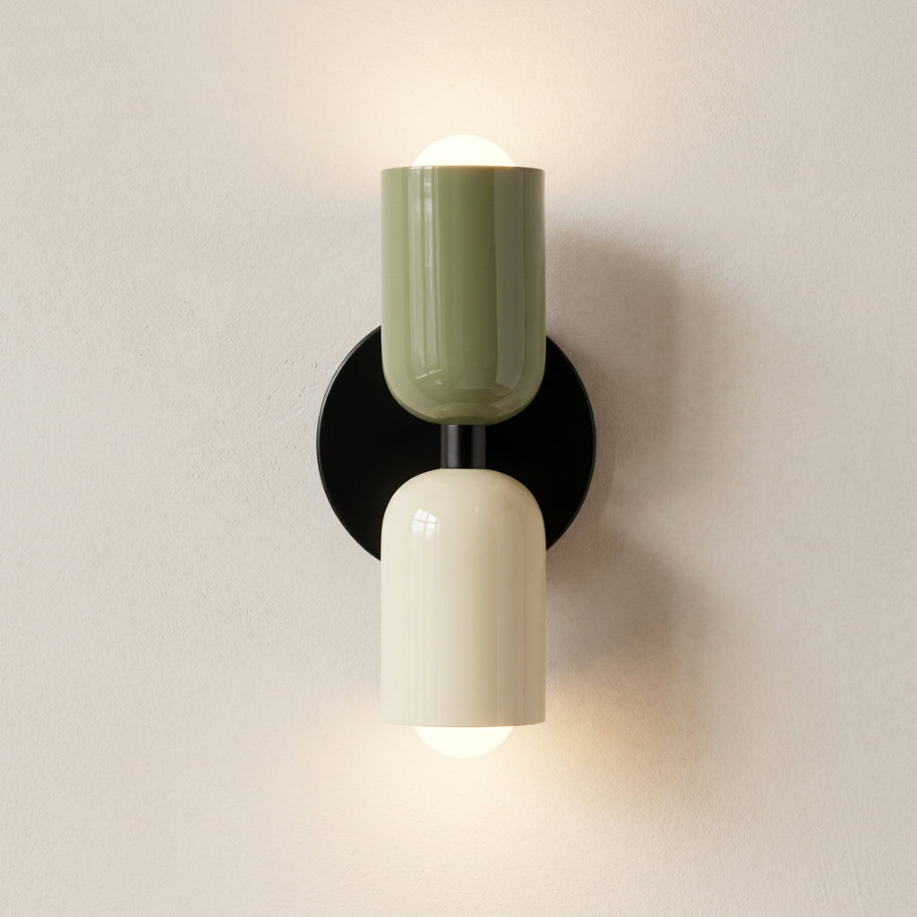 Modern wall sconce with green and beige shades on a white background