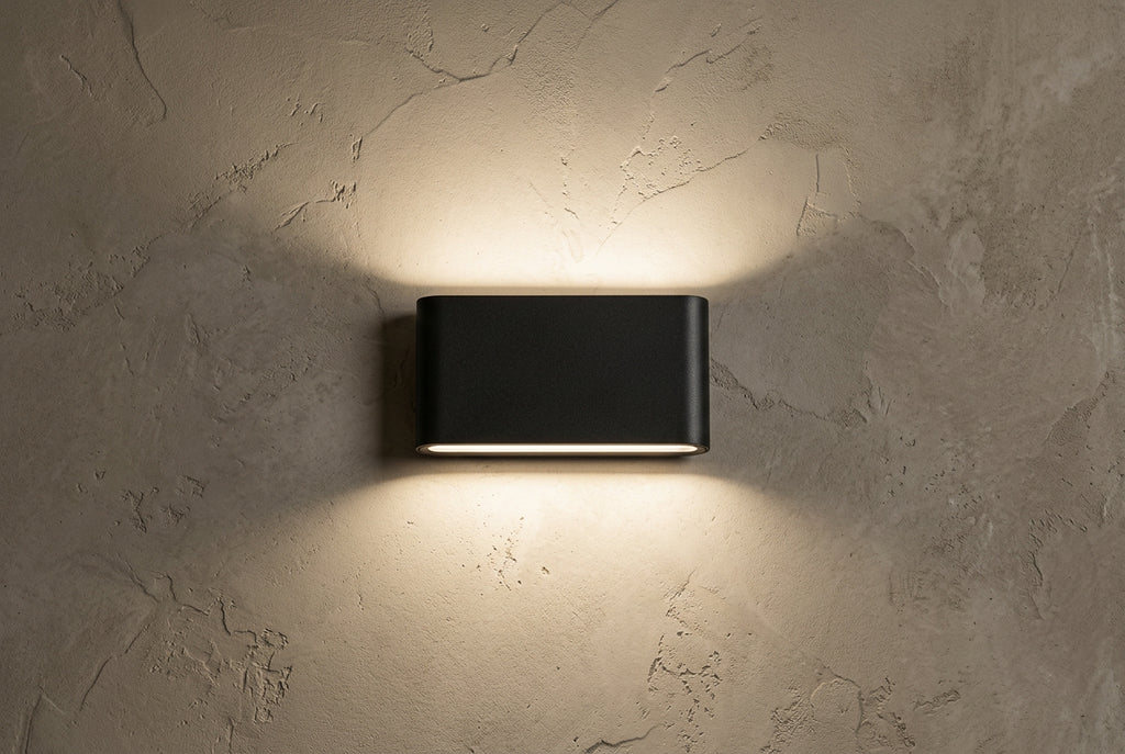 Black rectangular wall light fixture on a white background