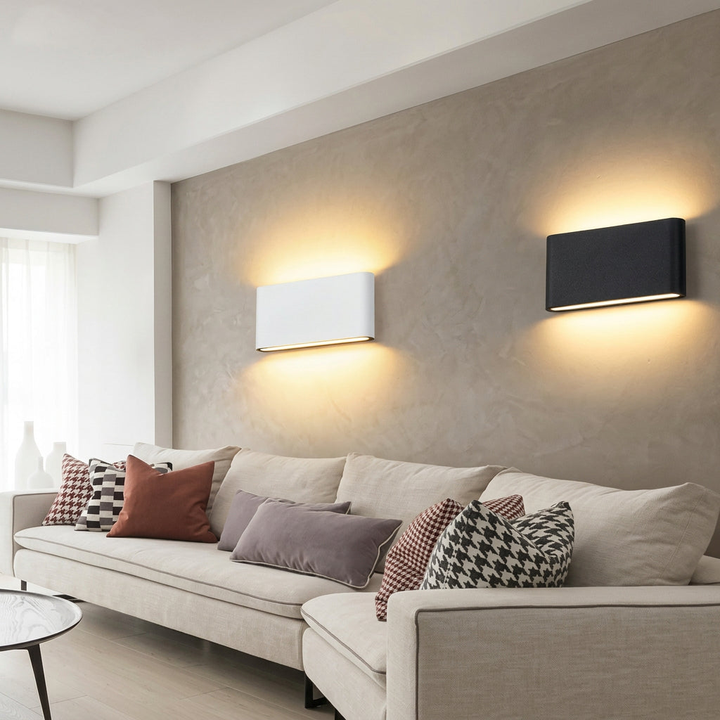 Modern living room with a white sofa and decorative pillows, featuring wall lamps.
