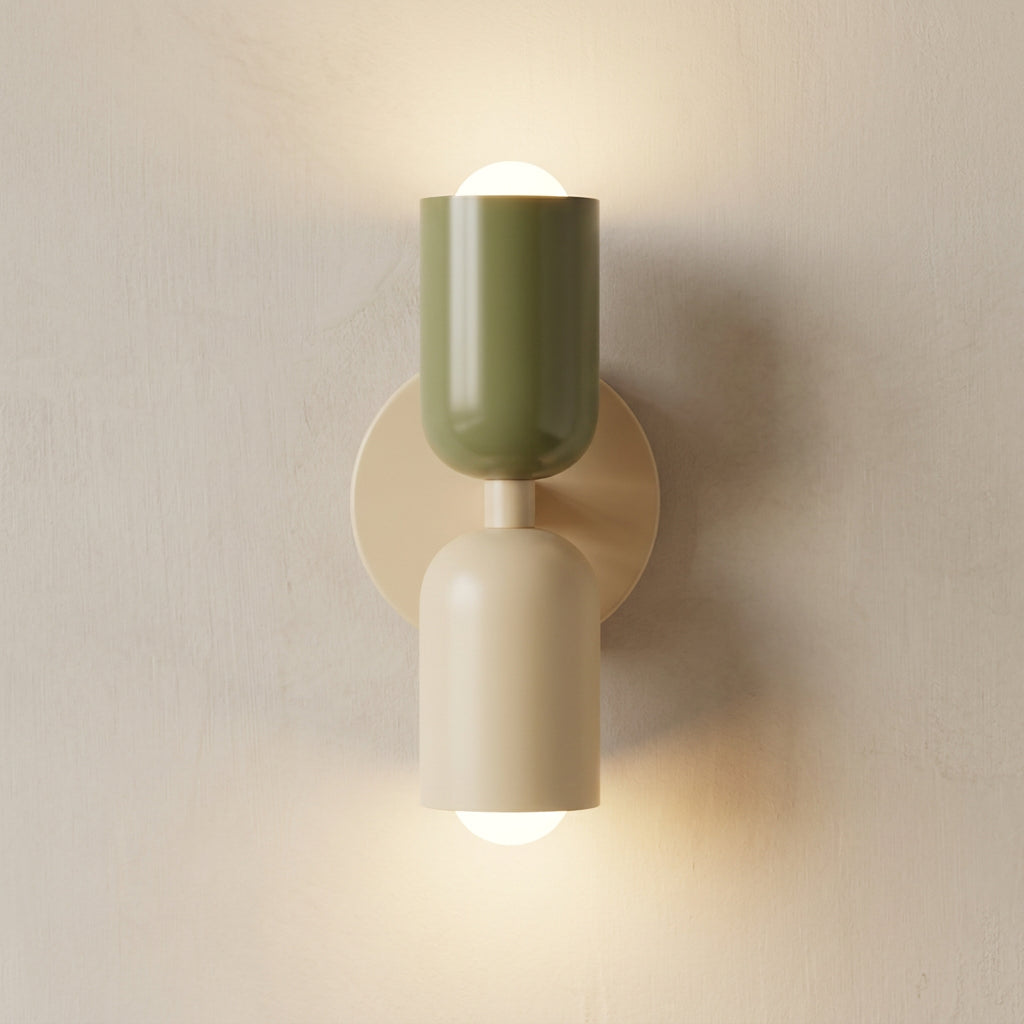 Wall-mounted light fixture with green and beige design on a plain background