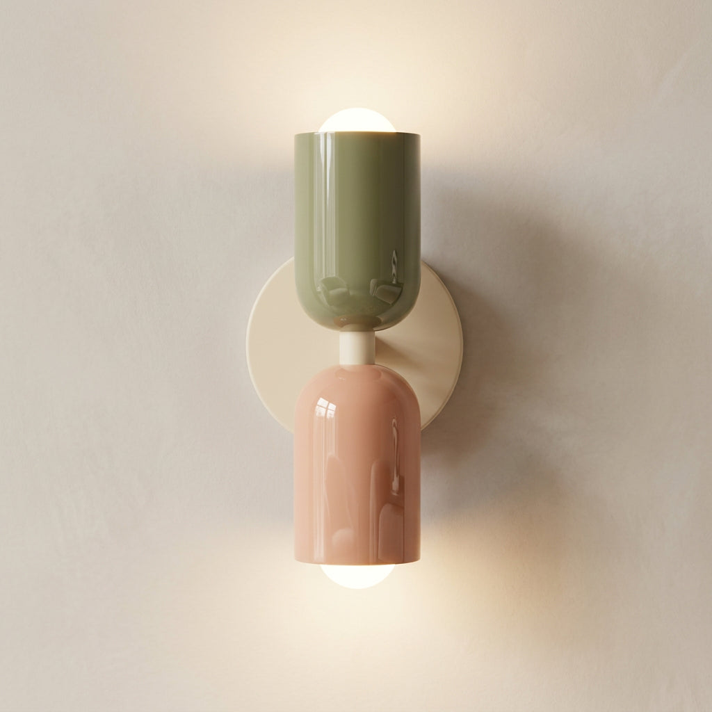 Decorative wall sconce with a green and pink design on a light background