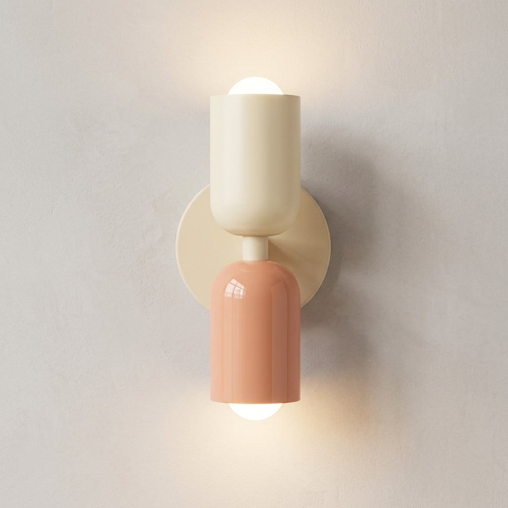 Two-toned wall sconce with beige and pink design on a light gray background